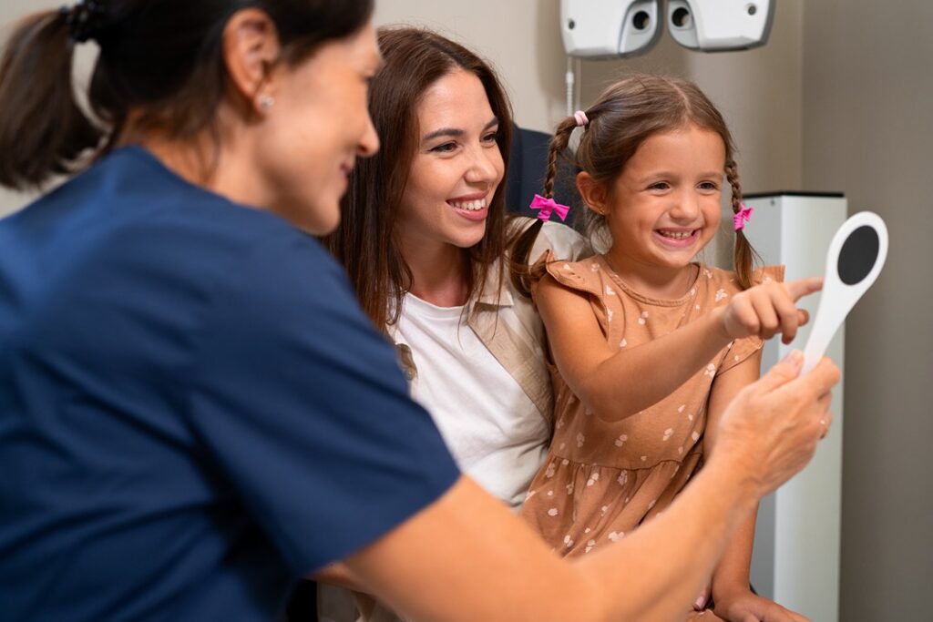 Girl smiling during a dental checkup.