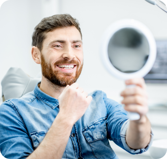 Man checking his smile in a mirror.