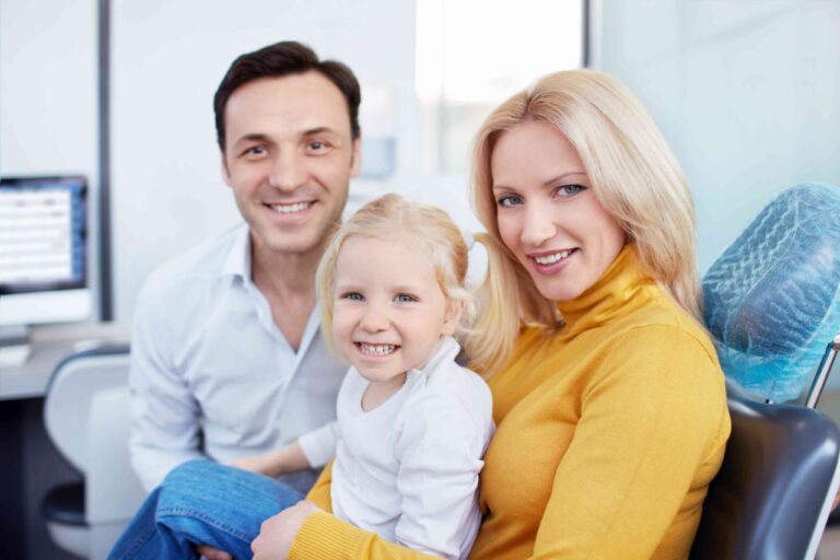 Smiling family at a dental clinic.
